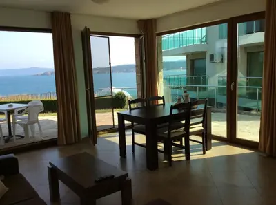 a dining room with a table and a view of the ocean at Seaside Apartment in Sozopol