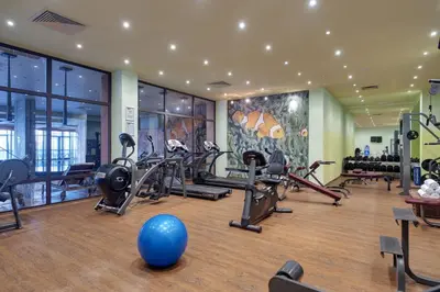 a gym with tread machines and a blue ball in the middle at Royal Beach Apartments in Sunny Beach