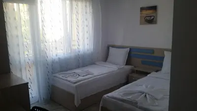 a small room with two beds and a window at Blue House in Tsarevo