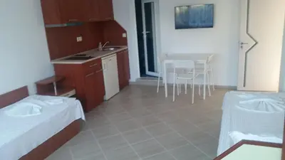 a room with a kitchen and a table and chairs at Blue House in Tsarevo