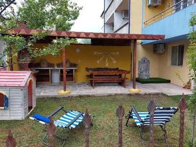 a patio with two chairs and a table and a bench at Blue House in Tsarevo