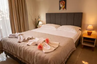 a bedroom with a bed with towels on it at Rodos House in Pomorie