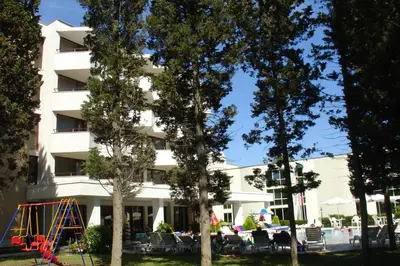 a hotel with a playground in front of a building at Hotel Klisura in Sunny Beach