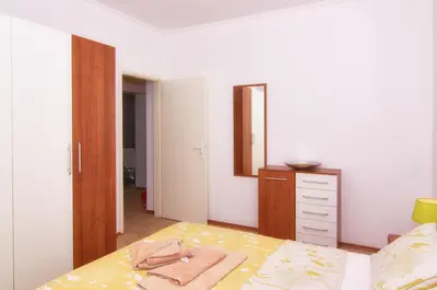 a bedroom with a bed with a dresser and a mirror at BulgariaVilla - Villa Knox in Bryastovets