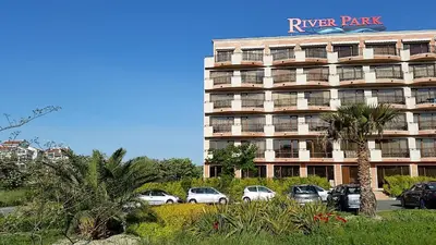 a large building with cars parked in front of it at Apartment in River Park in Sunny Beach