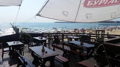 a restaurant with tables and chairs on the beach at Apartment in River Park in Sunny Beach