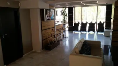 a living room with a couch and some windows at Apartment in River Park in Sunny Beach
