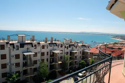 a view of a building with the ocean in the background at Hotel Saint Tatyana in Sveti Vlas