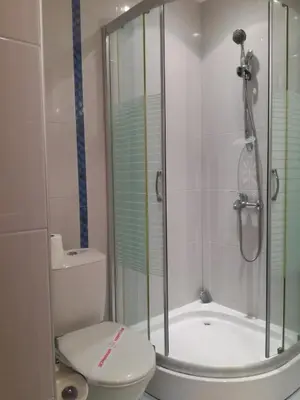 a bathroom with a shower and a toilet at Apolon Complex in Sozopol