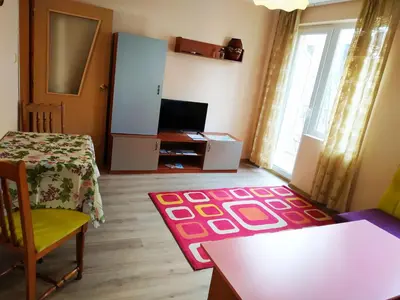 a living room with a table and a tv at CITY STAY in Varna in Varna City