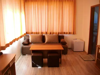 a living room with a couch and a table at Barex Family Hotel in Sozopol