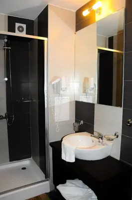 a bathroom with a sink and a shower at Flagman Hotel in Sozopol