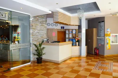a restaurant with a counter in a building at Flagman Hotel in Sozopol