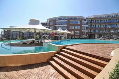 a swimming pool with stairs and a large building at Apartments Del Sol - Sunny Island Complex in Chernomorets