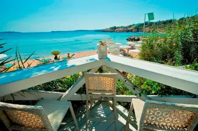 two chairs sitting on a balcony overlooking the ocean at Apartments Del Sol - Sunny Island Complex in Chernomorets