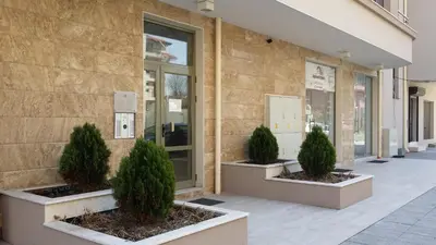 a building with three potted trees in front of it at Студио Изгрев in Burgas City