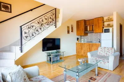 a living room with a glass table and a staircase at TSB Sunny Victory in Sunny Beach