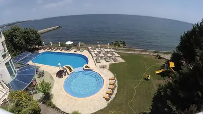 an overhead view of a swimming pool next to the ocean at Peter Hotel in Ravda