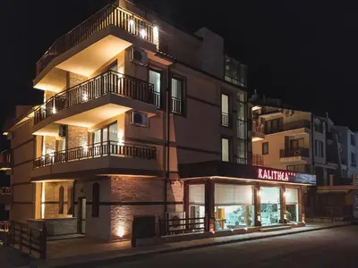 a tall building with lights on at night at Kalithea Family Hotel in Sozopol