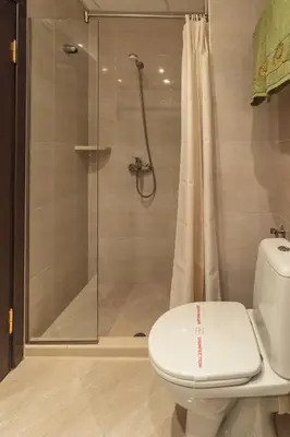 a bathroom with a shower and a toilet at Kalithea Family Hotel in Sozopol