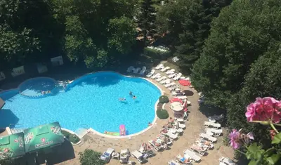 an overhead view of a large swimming pool with people in it at Hotel Olymp in Sunny Beach