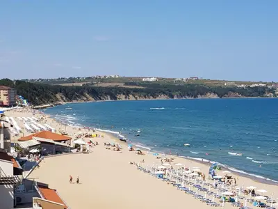 a beach with a lot of people and the ocean at Apartment with Sea View in Obzor Beach in Obzor
