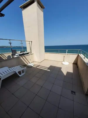 a balcony with a bench and a view of the ocean at Apartment with Sea View in Obzor Beach in Obzor