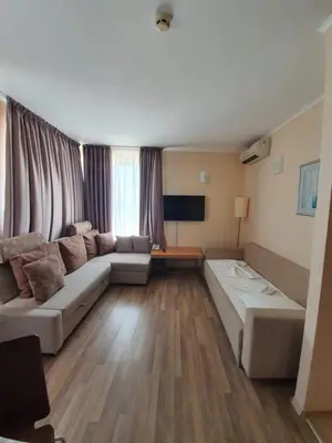 a living room with a couch and a television at Apartment with Sea View in Obzor Beach in Obzor
