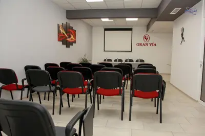 a conference room with a table and chairs at Gran Via in Burgas City