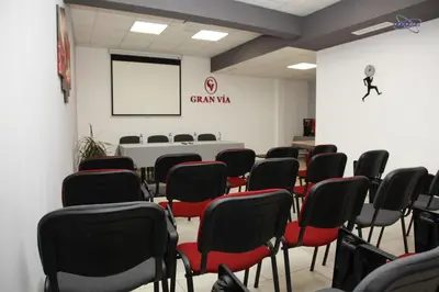 a conference room with chairs and a white wall at Gran Via in Burgas City