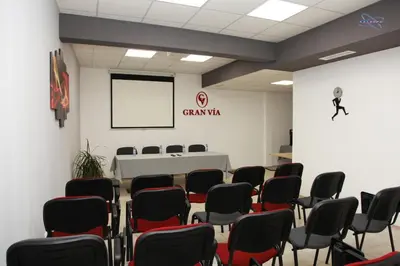 a room with chairs and a table and a screen at Gran Via in Burgas City