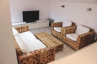 a living room with two chairs and a television at Family Hotel Casa del Mare in Sozopol