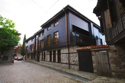 a building on a street next to a cobblestone street at Family Hotel Casa del Mare in Sozopol