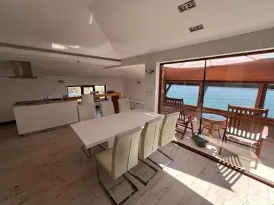 a kitchen and dining room with a table and chairs at Family Hotel Casa del Mare in Sozopol
