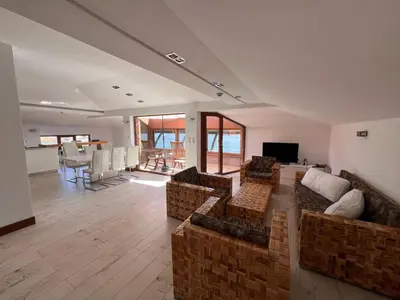 a large living room with couches and a dining room at Family Hotel Casa del Mare in Sozopol