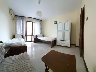 a living room with two beds and a table at Lazur Hotel in Ravda
