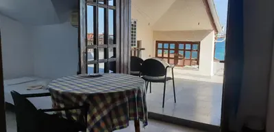 a dining room with a table and chairs in a room at Lazur Hotel in Ravda