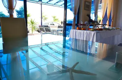 a table with a starfish on the floor of a room at Хотел Калипсо Блу in Primorsko