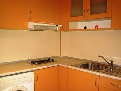 a small kitchen with a sink and a stove at Apartment Nadejda in Varna City