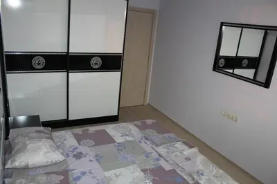 an empty room with a bed and a mirror at Paradise Day in Pomorie