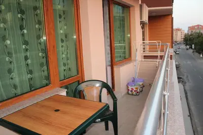 a table and a chair on a balcony at Paradise Day in Pomorie