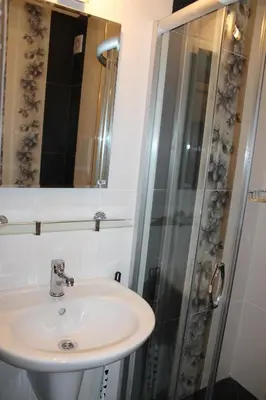a bathroom with a sink and a shower at Paradise Day in Pomorie