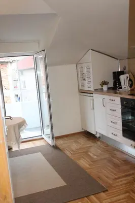 a small kitchen with a refrigerator and a stove at Paradise Corner in Pomorie