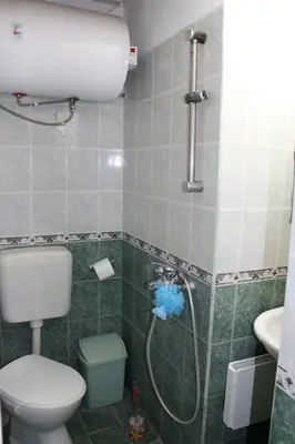 a bathroom with a shower and a toilet and a sink at Paradise Corner in Pomorie