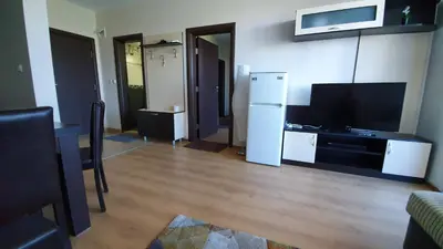 a living room with a refrigerator and a tv at апартамент CACAO RESIDENCE in Sunny Beach