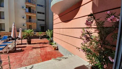 a brick walkway with flowers and a building at апартамент CACAO RESIDENCE in Sunny Beach