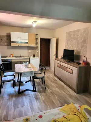 a kitchen and dining room with a table and chairs at Globus Kiten in Kiten