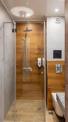 a shower with a glass door in a bathroom at Avenue Hotel in Burgas City