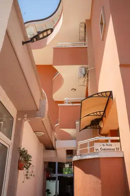 an alleyway between two buildings with a balcony at Marianas Guesthouse in Obzor