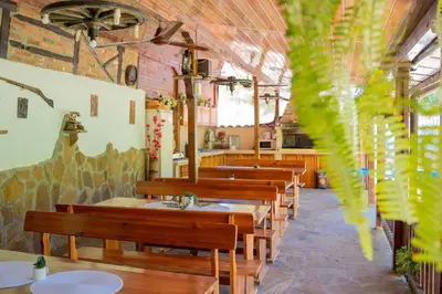 a row of tables and benches in a restaurant at Marianas Guesthouse in Obzor